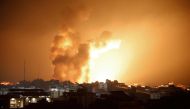 Fire and smoke rises above buildings during an Israeli air strike in Gaza City on October 8, 2023. (Photo by Eyad Baba / AFP)