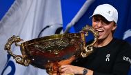 Poland's Iga Swiatek holds the winning trophy after defeating Russia's Liudmila Samsonova in the women's singles final match of the WTA China Open tennis tournament in Beijing on October 8, 2023. (Photo by Pedro Pardo / AFP)