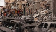 Palestinians inspect the destruction in a neighbourhood heavily damaged by Israeli airstrikes on Gaza City's Shati refugee camp early on October 9, 2023. (Photo by Mahmud Hams / AFP)
