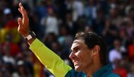 Spain's Rafael Nadal waves as he celebrates after victory over Norway's Casper Ruud during their men's singles final match on day fifteen of the Roland-Garros Open tennis tournament at the Court Philippe-Chatrier in Paris on June 5, 2022. Photo by Anne-Christine POUJOULAT / AFP