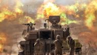 An Israeli army self-propelled howitzer fires rounds near the border with Gaza in southern Israel on October 11, 2023. (Photo by Jack Guez / AFP)