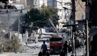 Palestinians with their belongings flee to safer areas in Gaza City after Israeli air strikes, on October 13, 2023. Photo by MOHAMMED ABED / AFP