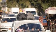 Palestinians with their belongings flee northern Gaza City following the Israeli army's warning to leave their homes before an expected ground offensive, in Gaza City on October 13, 2023. (Photo by Mahmud Hams / AFP)