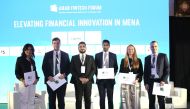 Arab Fintech Forum President Malik Shishtawi along with the speakers at the Ritz-Carlton Doha. 