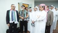 President of Qatar Press Center Saad Mohammed Al Rumaihi with photojournalist Karim Jaafar (first left) and other officials and guests touring the exhibition at the headquarters of the center yesterday.  Pic: Ahmed Barakat