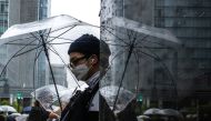 A man uses an umbrella to shelter from the rain at the Ginza district in Tokyo on June 2, 2023. Photo by Philip FONG / AFP

