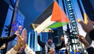 Protesters shout slogans and wave a Palestinian flag during a rally in support of Palestinians in Istanbul on October 18, 2023. (Photo by Umit Turhan Coskun / AFP)

