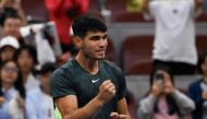 Spain's Carlos Alcaraz celebrates his victory against Italy's Lorenzo Musetti in their men's singles match during the China Open tennis tournament at the National Tennis Center in Beijing on October 1, 2023. (Photo by Pedro PARDO / AFP)

