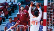 A Qatar player prepares to strike during match against India. 