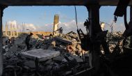 People search through the rubble of a destroyed building following Israeli bombardment in Rafah in the southern of Gaza Strip on October 19, 2023. Photo by MOHAMMED ABED / AFP