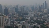 The city skyline is pictured amid high levels of air pollution in Bangkok on October 18, 2023. Photo by Alex OGLE / AFP