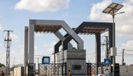 This picture taken on October 20, 2023 shows a view of the gate to the Rafah border crossing with Egypt in the southern Gaza Strip. (Photo by MOHAMMED ABED / AFP)