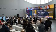 Visitors attend to the presentation of a book during the 2023 World Science Fiction Convention in Chengdu, in China's southwest Sichuan province on October 21, 2023. (Photo by Hector Retamal / AFP)