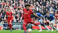 Liverpool's Egyptian striker #11 Mohamed Salah scores the opening goal from the penalty spot during the English Premier League football match between Liverpool and Everton at Anfield in Liverpool, north west England on October 21, 2023. (Photo by Paul ELLIS / AFP) 