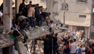 Rescuers pull a child out of the rubble of a building hit in an Israeli air strike in Khan Yunis in the southern Gaza Strip on October 24, 2023. (Photo by Mahmud Hams / AFP)
