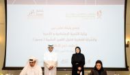 Minister of Labour H E Dr. Ali bin Smaikh Al Marri (left)  and Minister of Social Development and Family H E Maryam bint Ali bin Nasser Al Misnad (right) witness signing of the agreement.