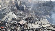 People search for survivors and the bodies of victims through the rubble of buildings destroyed during Israeli bombardment, in Khan Yunis in the southern Gaza Strip on October 26, 2023, amid the ongoing battles between Israel and the Palestinian group Hamas. Photo by Mahmud HAMS / AFP