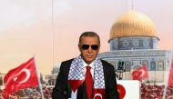 Turkish President Tayyip Erdogan, wearing a scarf with the Palestinian and Turkish flags, stands on the stage during a rally organised by the AKP party in solidarity with the Palestinians in Gaza, in Istanbul on October 28, 2023. (Photo by Handout / Turkish Presidency Press Office / AFP) 