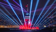 A photograph taken in Istanbul on October 29, 2023, shows the Turkish flag waving on the illuminated Maiden's Tower during celebrations to mark the 100th anniversary of the Turkish Republic. (Photo by Yasin Akgul / AFP)