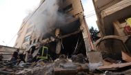 Palestinian firefighters survey damaged stores following an Israeli military raid on the Jenin Palestinian refugee camp, in Jenin in the occupied northern West Bank on October 30, 2023. (Photo by Jaafar Ashtiyeh / AFP)
