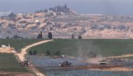 Israeli tanks and bulldozers positioned in the north of the Gaza Strip, on October 30, 2023. (Photo by Jack Guez / AFP)