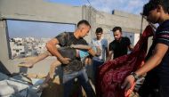 Palestinians carry the body of a victim in the aftermath of an Israeli strike in the Jabalia camp, on November 1, 2023. Photo by Bashar TALEB / AFP