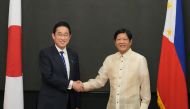 Philippine President Ferdinand Marcos Jr. (right) shakes hands with Japanese Prime Minister Fumio Kishida at the Malacanang presidential palace in Manila on November 3, 2023. (Photo by Aaron Favila / POOL / AFP)