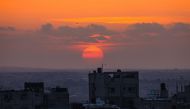 The sunsets over Egypt's border with Rafah, in the southern Gaza Strip on November 5, 2023. (Photo by Said Khatib / AFP)
