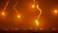 This picture taken from a position near Sderot along the Israeli border with the Gaza Strip on November 5, 2023, shows flares dropped by Israeli forces above the Palestinian enclave. (Photo by Aris Messinis / AFP)
