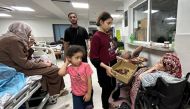 Patients and internally displaced people are pictured at Al-Shifa hospital in Gaza City on November 10, 2023. (Photo by Ismail Zanoun / AFP)