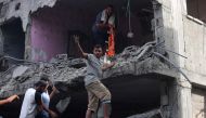 People search for victims in a building hit by Israeli bombing in Rafah in the southern Gaza Strip, on November 11, 2023. Photo by SAID KHATIB / AFP