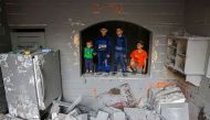 Children look on inside a damaged building following strikes on Rafah in the southern Gaza Strip on November 12, 2023. (Photo by Mohammed Abed / AFP)