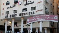People wait outside Gaza City's Al-Quds Hospital on October 29, 2023. Photo by Khoder al-Zaanoun / AFP
