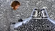 British artist Sam Cox, better known as Mr Doodle, draws on a model spaceship for a live art performance at Central MTR Station in Hong Kong on November 19, 2023. (Photo by Isaac Lawrence / AFP)