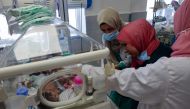 Palestinian medics care for premature babies evacuated from Al-Shifa Hospital to the Emirates hospital in Rafah in the southern Gaza Strip, on November 19, 2023. (Photo by Mohammed Abed / AFP)