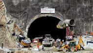 Rescue workers stand at an entrance of the under construction road tunnel, days after it collapsed in the Uttarkashi district of India's Uttarakhand state on November 18, 2023. Photo by AFP

