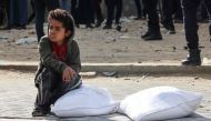 Palestinians receive bags of flour at the United Nations Relief and Works Agency for Palestine Refugees (UNRWA) distribution center in the Rafah refugee camp in the southern Gaza Strip on November 21, 2023. Photo by SAID KHATIB / AFP