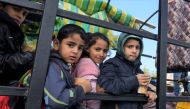 Palestinian children fleeing Gaza City to take refuge in the southern Gaza Strip on November 21, 2023. (Photo by Mohammed Abed / AFP)
