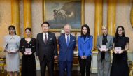 Britain's King Charles III (C) stands with South Korea's President Yoon Suk Yeol (3L), South Korea's First Lady Kim Keon Hee (3R), and K-Pop band Blackpink's members, from left, Lalisa Manoban, Jennie Kim, Roseanne Park and Jisoo Kim following a special investiture ceremony to present the band's members with Honorary MBEs (Member of the Order of the British Empire), at Buckingham Palace in London on November 22, 2023, on the second day of the President's three-day state visit to the UK. (Photo by Victoria Jones / POOL / AFP)
