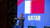 An official draws Qatar during the draw ceremony in Doha yesterday. 