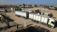 Trucks carrying humanitarian aid enter the Gaza Strip via the Rafah crossing with Egypt, hours after the start of a four-day truce, on November 24, 2023. Photo by SAID KHATIB / AFP