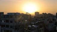 The sun rises over Rafah in the southern Gaza Strip shortly before the start of a four-day truce, on November 24, 2023. Photo by Mohammed ABED / AFP