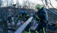 This handout photograph taken and released by Ukrainian Emergency Service on November 25, 2023, shows rescuers working to extinguish a fire at the site of a drone attack in Kyiv (Photo by Handout / Ukrainian Emergency Service / AFP)