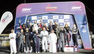 The podium winners pose for a photo with officials after the penultimate round of the QNC.