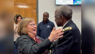 Kris Feeney and Col. Ned Felder hug at their first meeting, with his oldest son in the background. Courtesy of South Carolina State University.