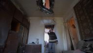 A local resident reacts standing inside her flat damaged by recent shelling in Donetsk, Russian-controlled Ukraine, on November 28, 2023, amid the Russia-Ukraine conflict. (Photo by STRINGER / AFP)
