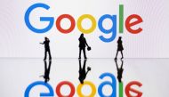 This illustration photograph taken on October 30, 2023 in Mulhouse, eastern France, shows figurines next to a screen displaying a logo of Google, a US multinational technology company. Photo by SEBASTIEN BOZON / AFP