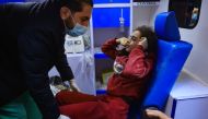An injured girl sits in an ambulance following an Israeli air strike on the Rafah refugee camp in the southern Gaza Strip on December 1, 2023. Photo by SAID KHATIB / AFP