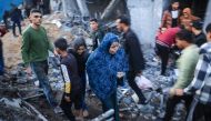 Palestinians check the damages after an Israeli strike in Rafah in the southern Gaza Strip on December 3, 2023. (Photo by Said Khatib / AFP)