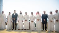 Deputy CEO Business Support, Services & Human Resources at Ahlibank, Mohamed Mousa Al Namla along with other officials poses for a picture.
